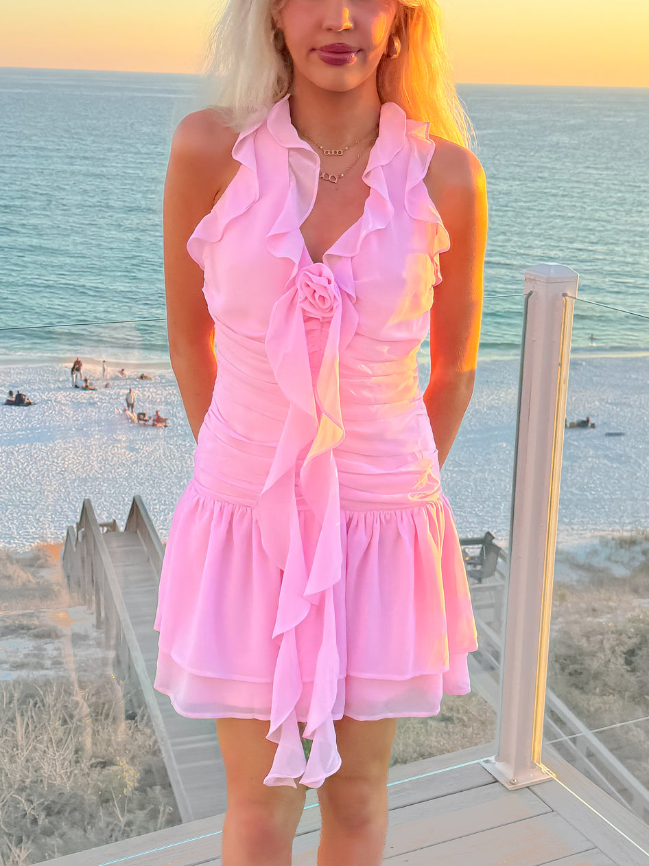 Pink halter tie neck dress with shirring and rosette front detail