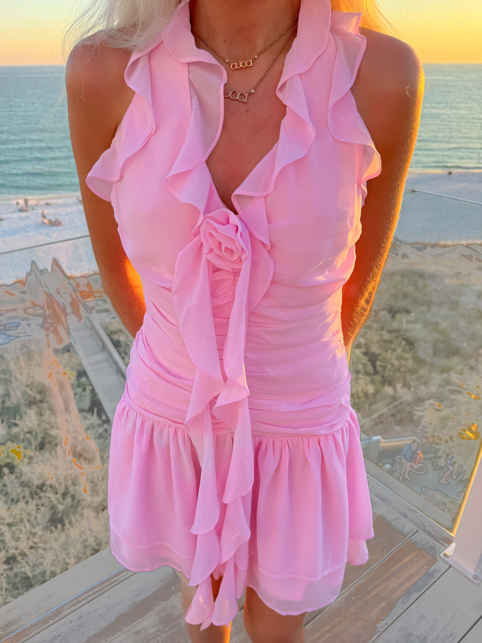 close up of pink halter dress with rosette front detail