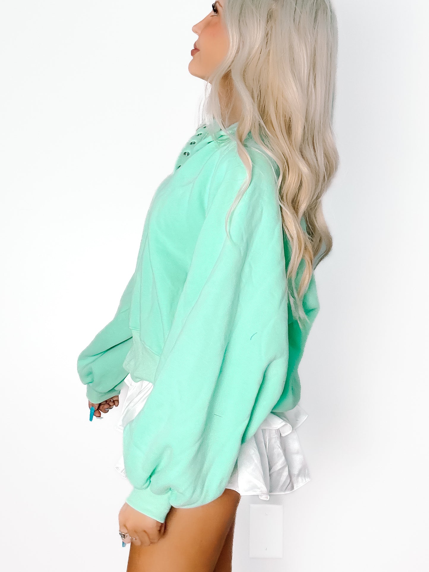 Seafoam green pullover, relaxed fit, shown on model against white background.