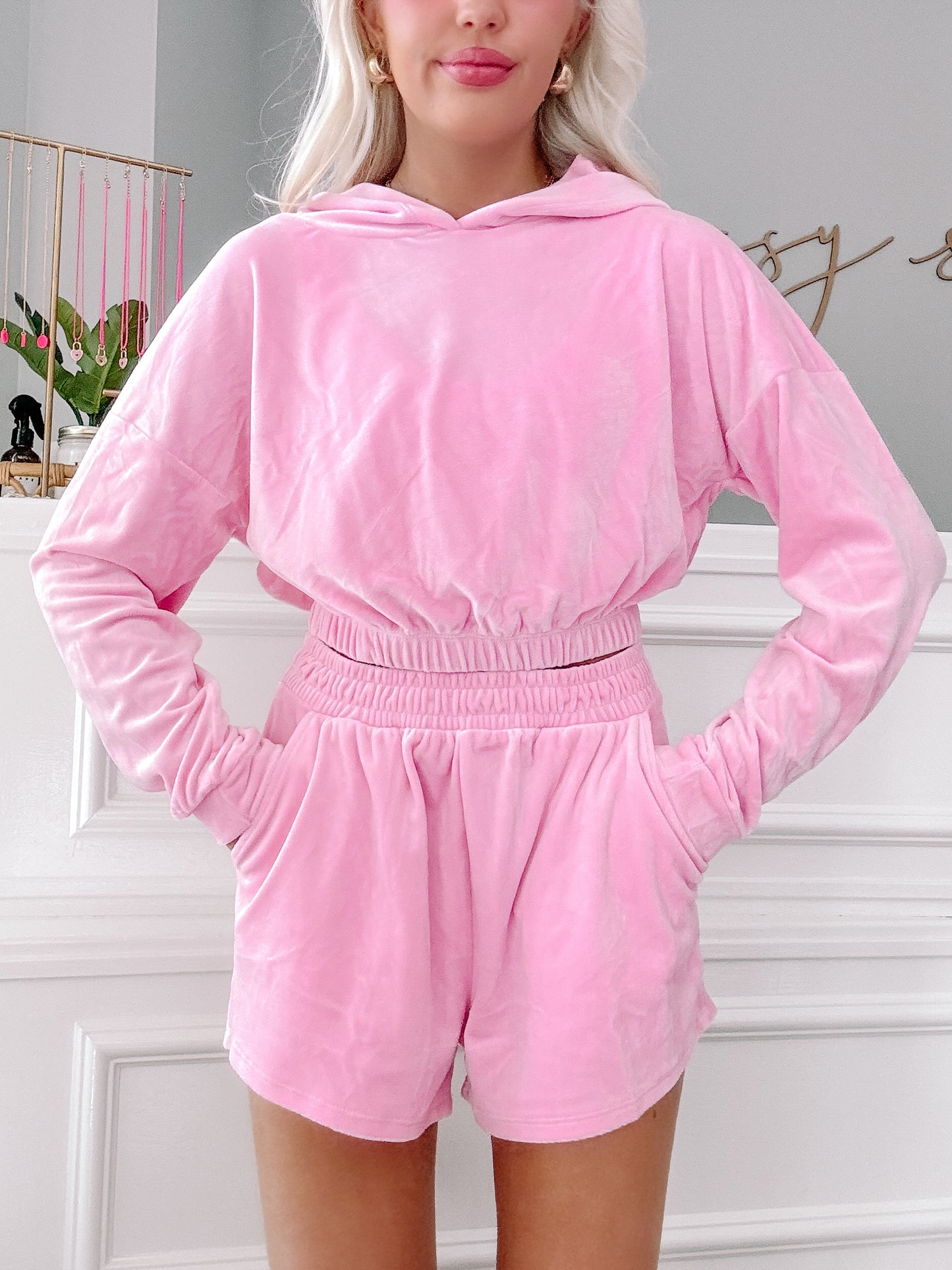 Pink velour hoodie and shorts lounge set; soft, comfortable fabric.
