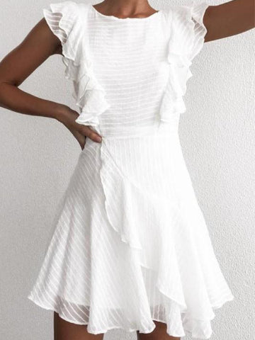 White eyelet mini dress with ruffle detailing and a flirty, asymmetrical hem.