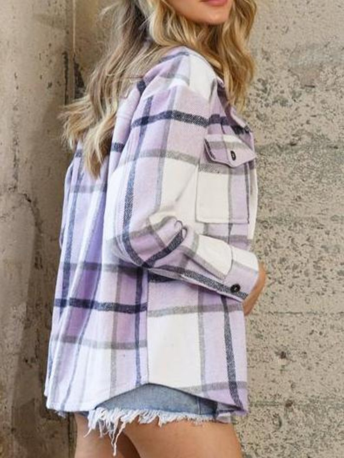 Lavender and white plaid shacket, long sleeves, worn over denim shorts.