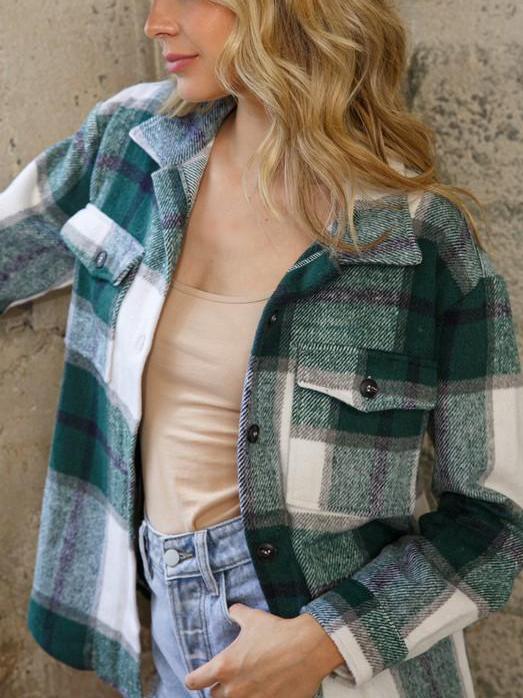 Green and white plaid shacket, worn over a beige camisole and light wash jeans.
