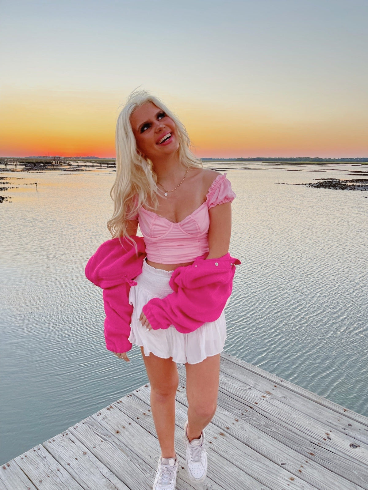Wildest Dreams Top in pink from Sassy Shortcake styled as a pretty preppy top with puff sleeves and ruched bodice worn with a white skirt for sunset on the dock photos