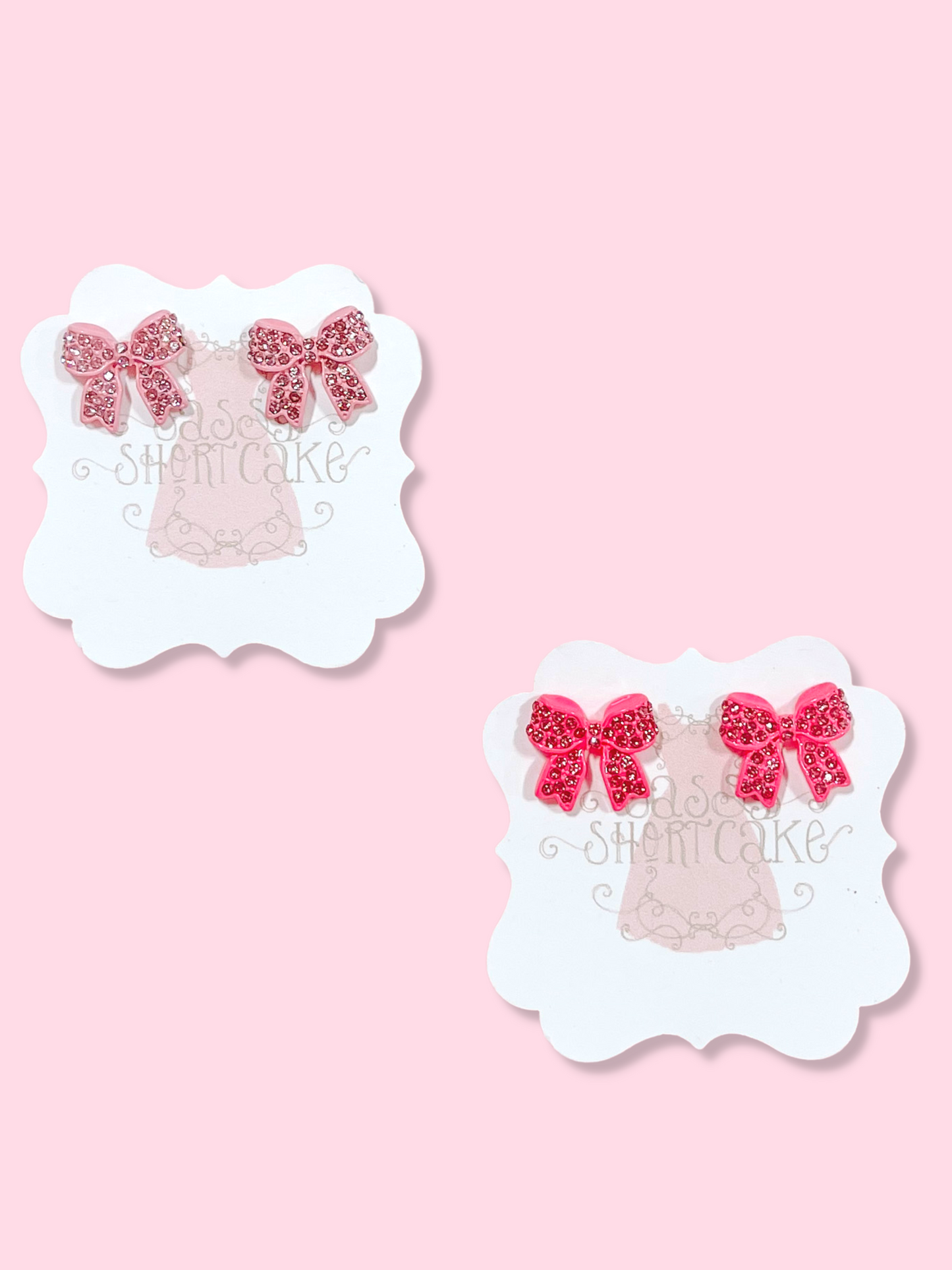 Pink bedazzled bow earrings by Sassyshortcake