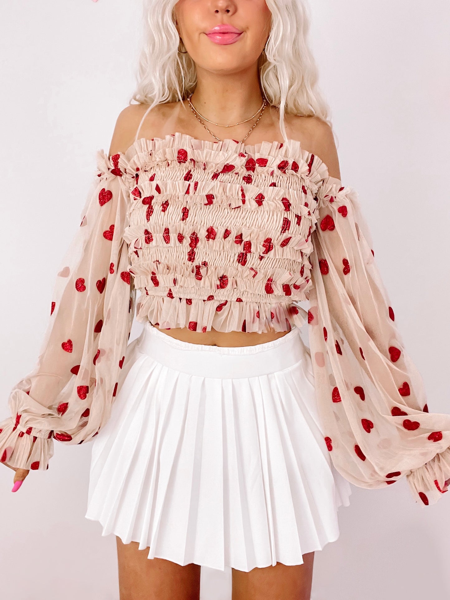 Latte in Love Heart Top: Beige sheer mesh off-shoulder top with red glitter hearts, long sleeves, and smocked bodice.