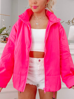 Hot pink Zip and Zap puffer jacket with zipper closure.
