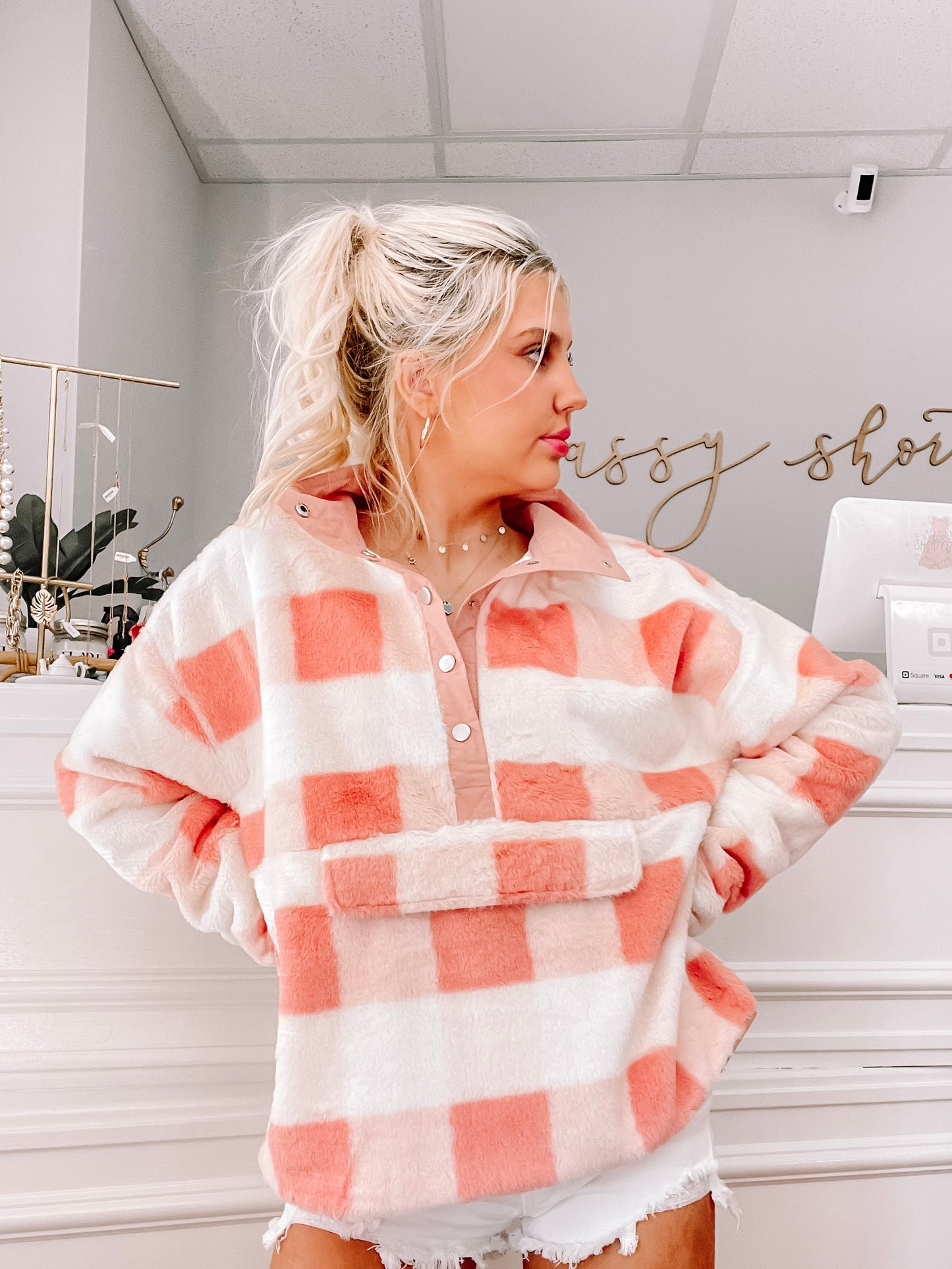Soft pink and white fuzzy plaid pullover; cozy, casual style.