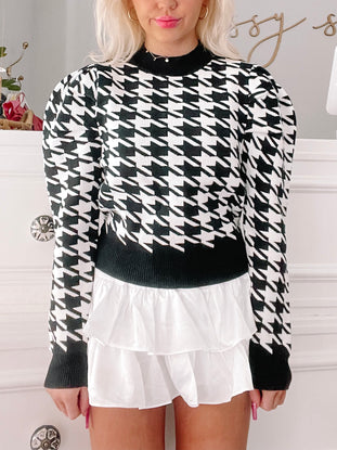 Black and white houndstooth puff-sleeve sweater