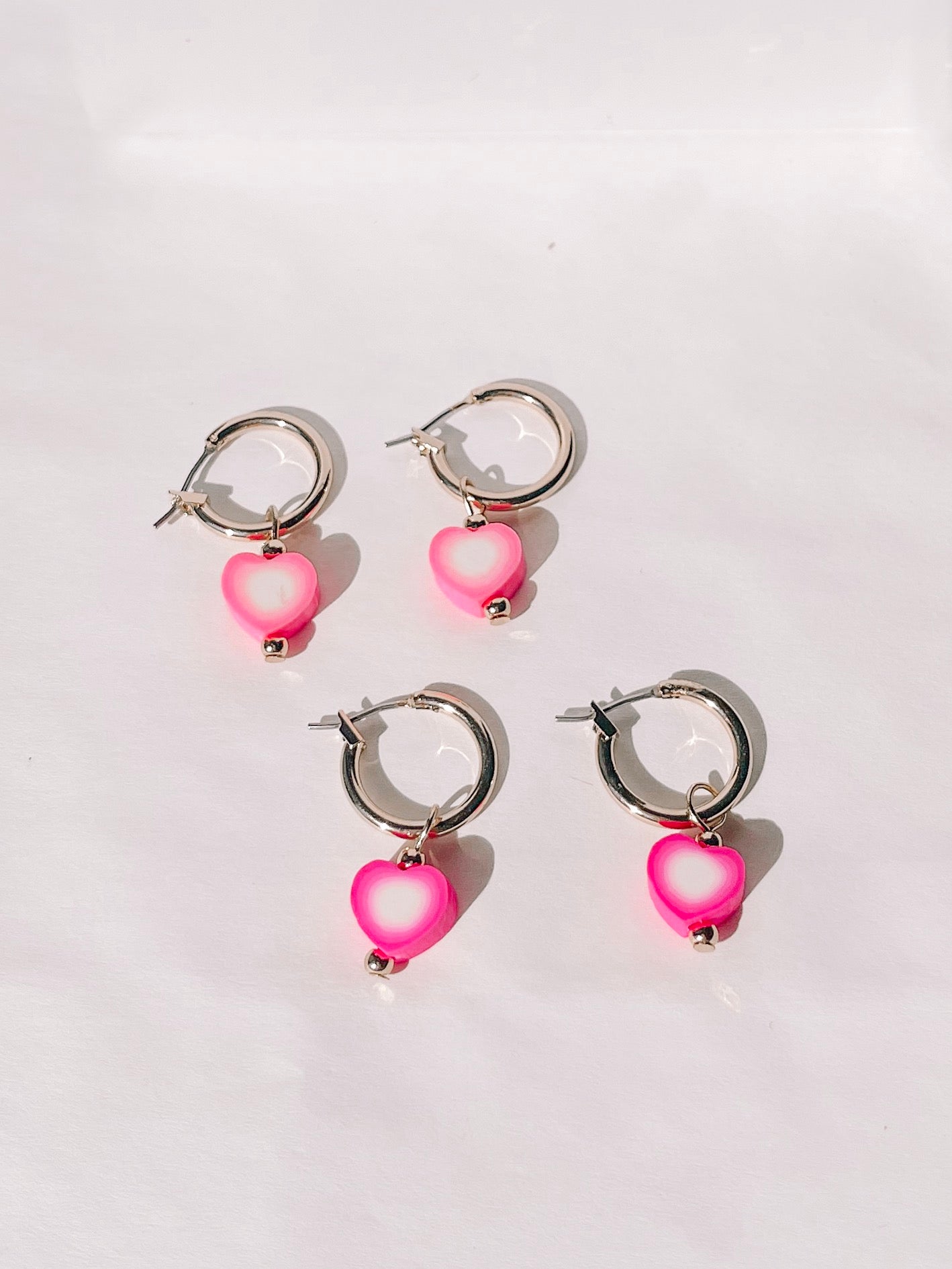 Pink and white heart charm gold hoop earrings