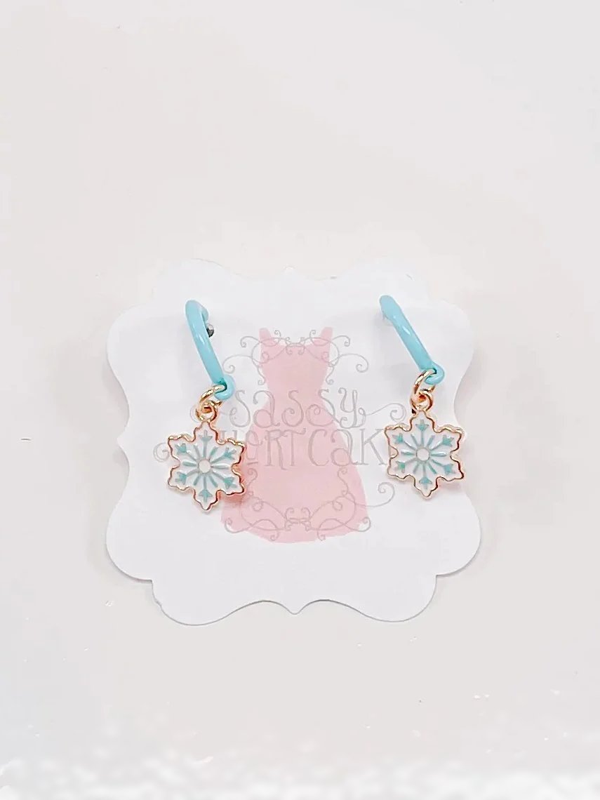 Ice Snowflake earrings with light blue hoops and gold snowflake charms.