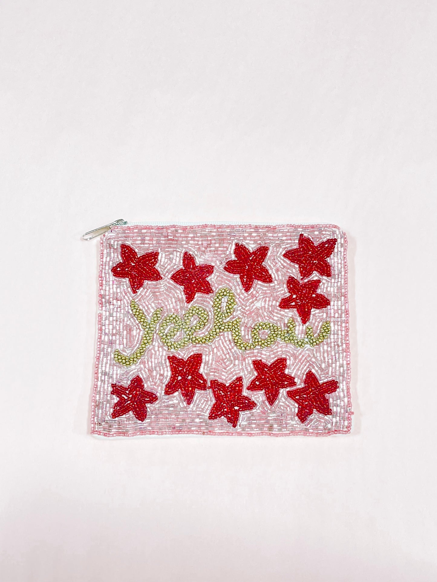 Pink beaded Yeehaw pouch with red flower accents and gold lettering.