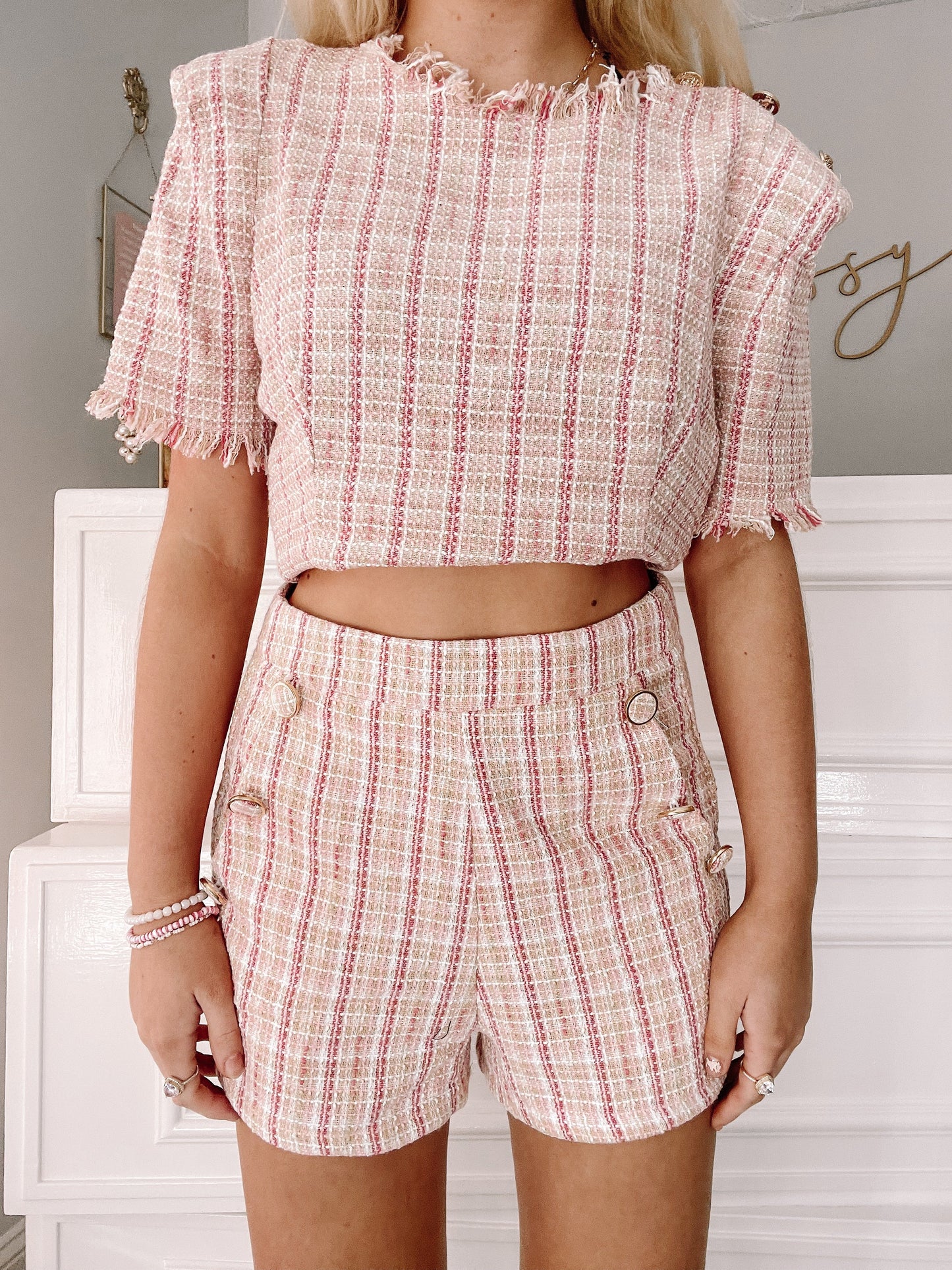 Pink and white tweed crop top and shorts set, textured fabric.