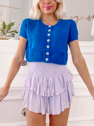 Royal blue Kallie cardigan with short sleeves and button front.