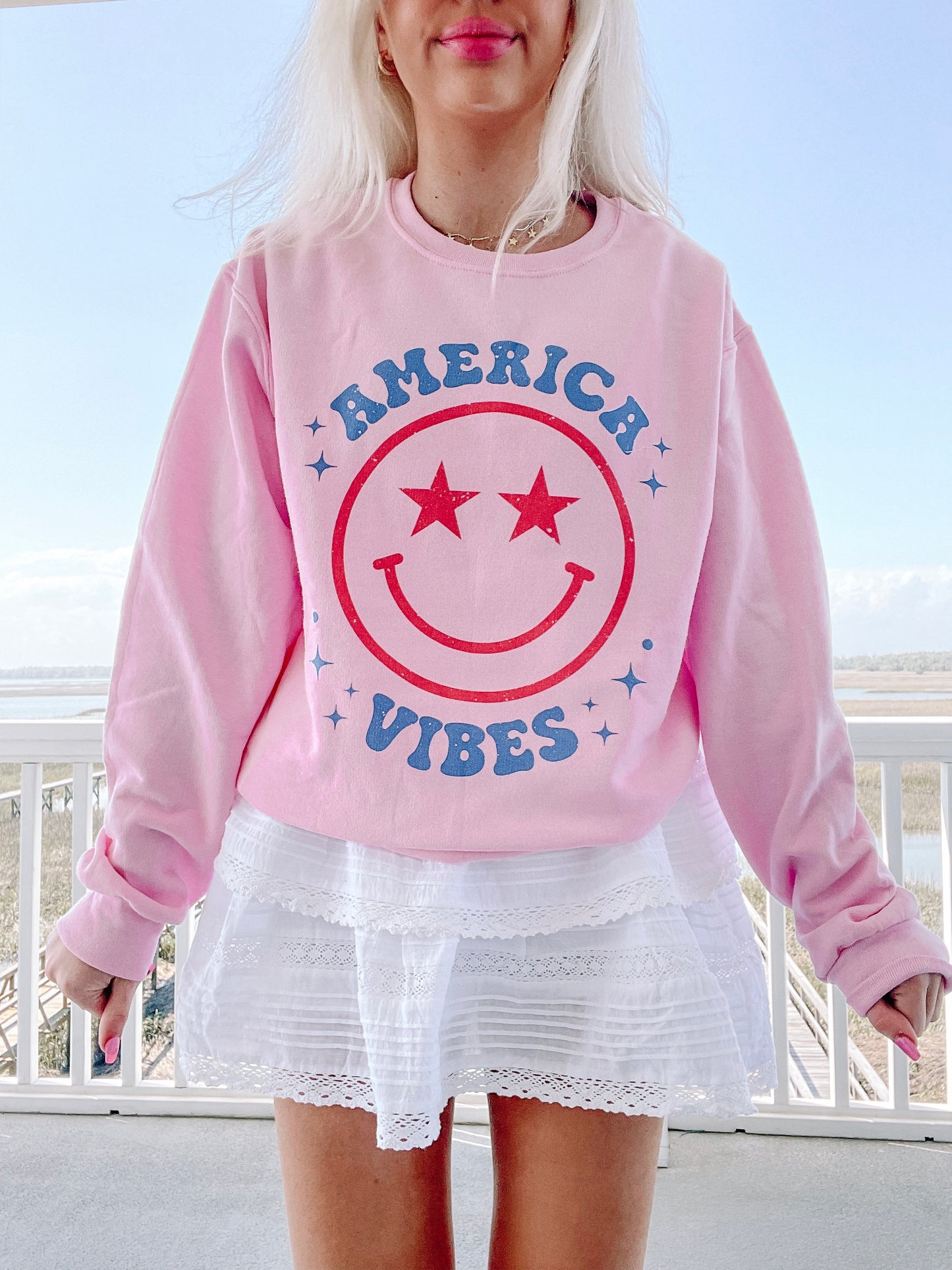 Pink America Vibes sweatshirt with retro smiley face graphic