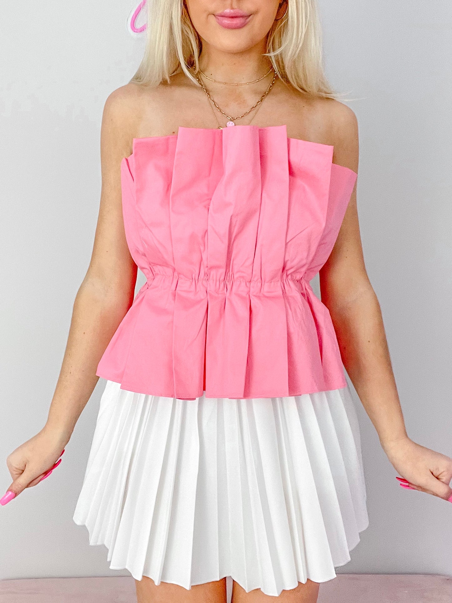 Pink Modern Muse Top: Pleated, strapless top with cinched waist, paired with white pleated mini skirt.