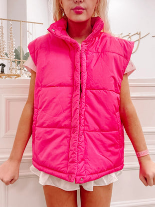 Hot pink puffer vest, sleeveless, zipper closure.