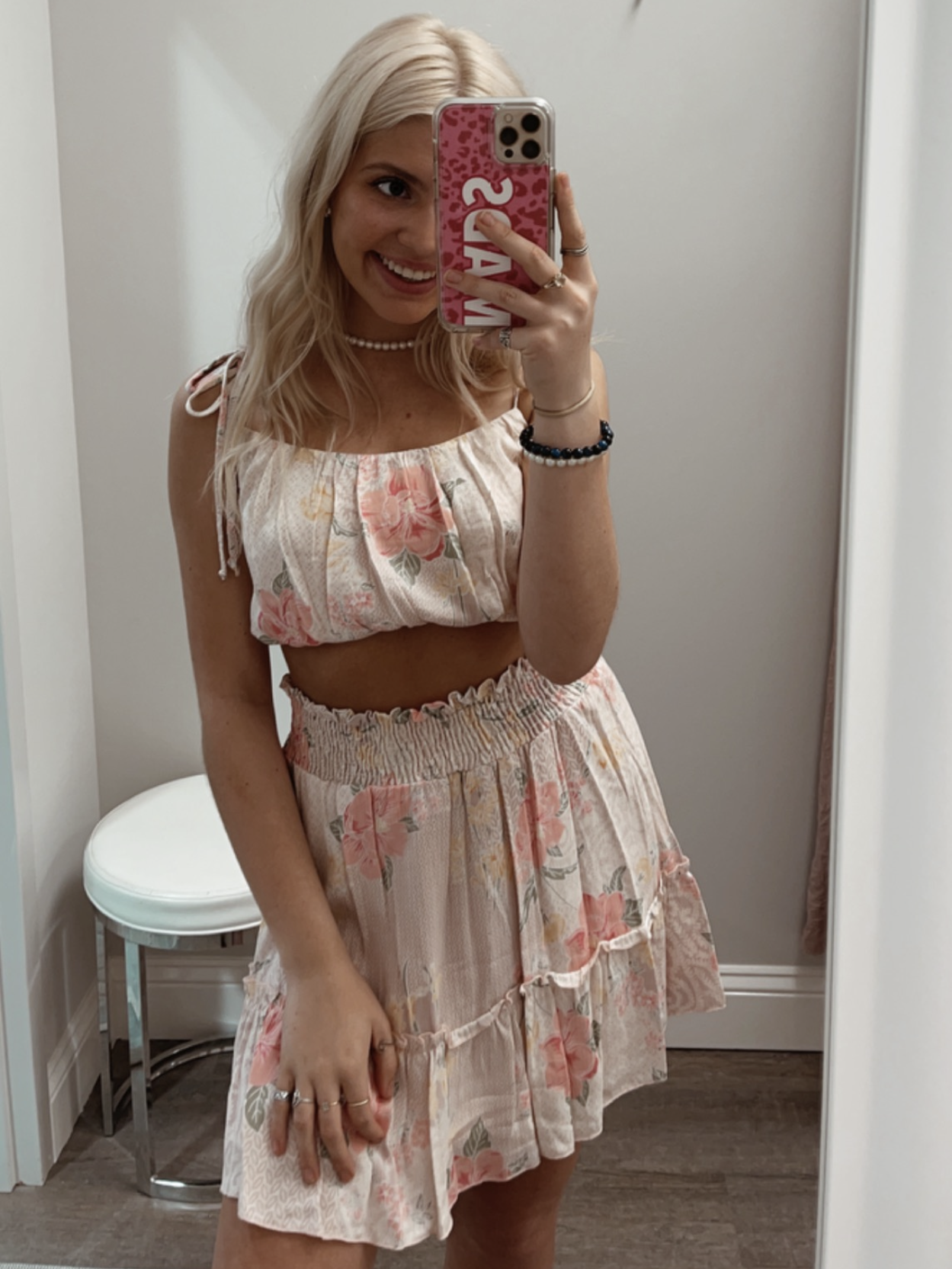 Petal Pink floral print mini skirt with elastic waistband and tiered ruffle hem.