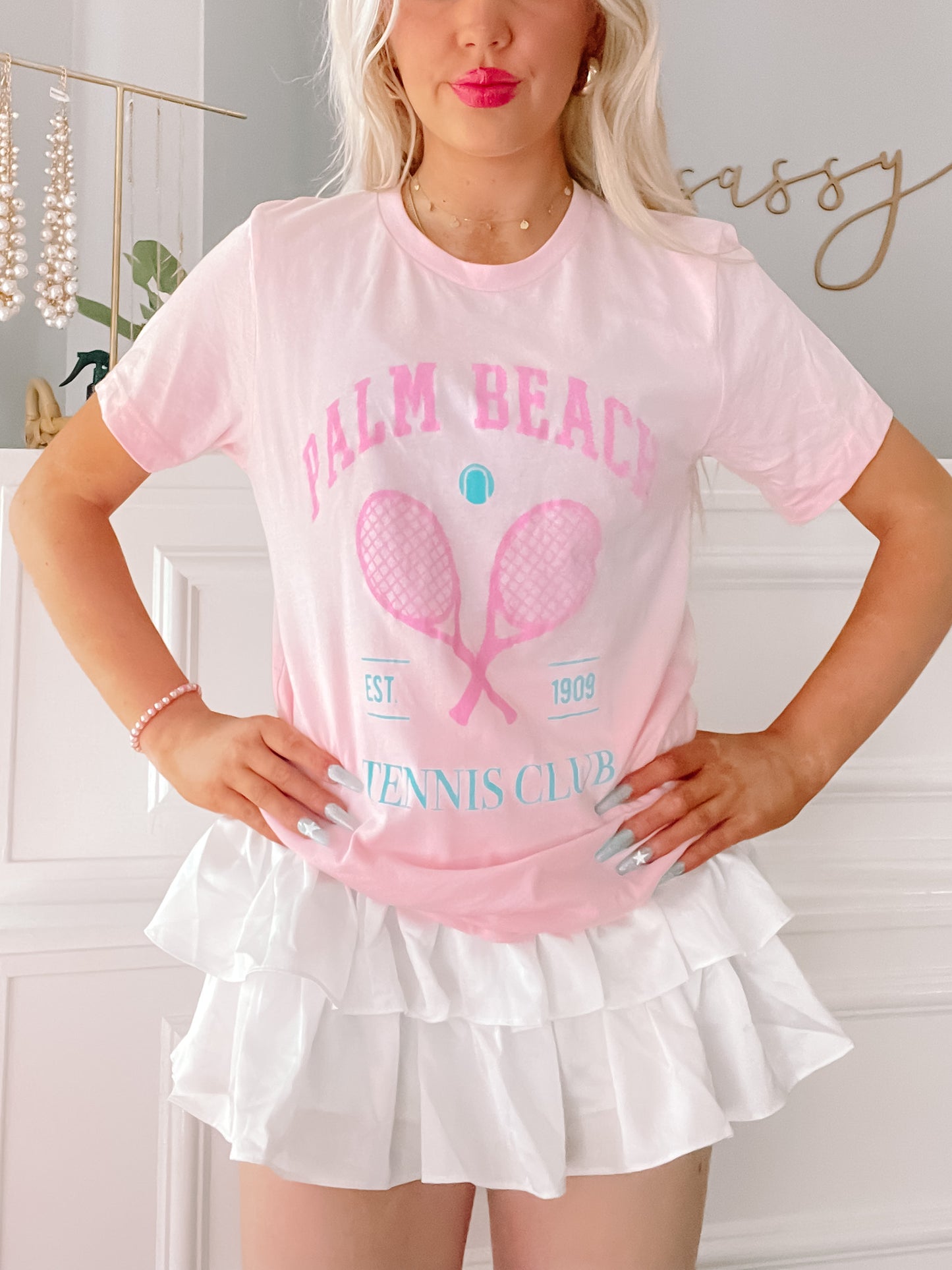 Pink tie-dye tennis tee featuring crossed rackets and Palm Beach Tennis Club graphic.