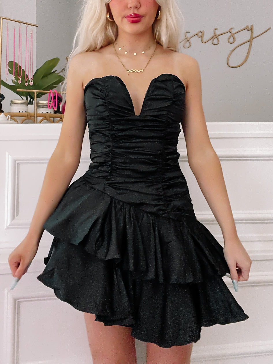 Black strapless ruffle mini dress; perfect for parties.