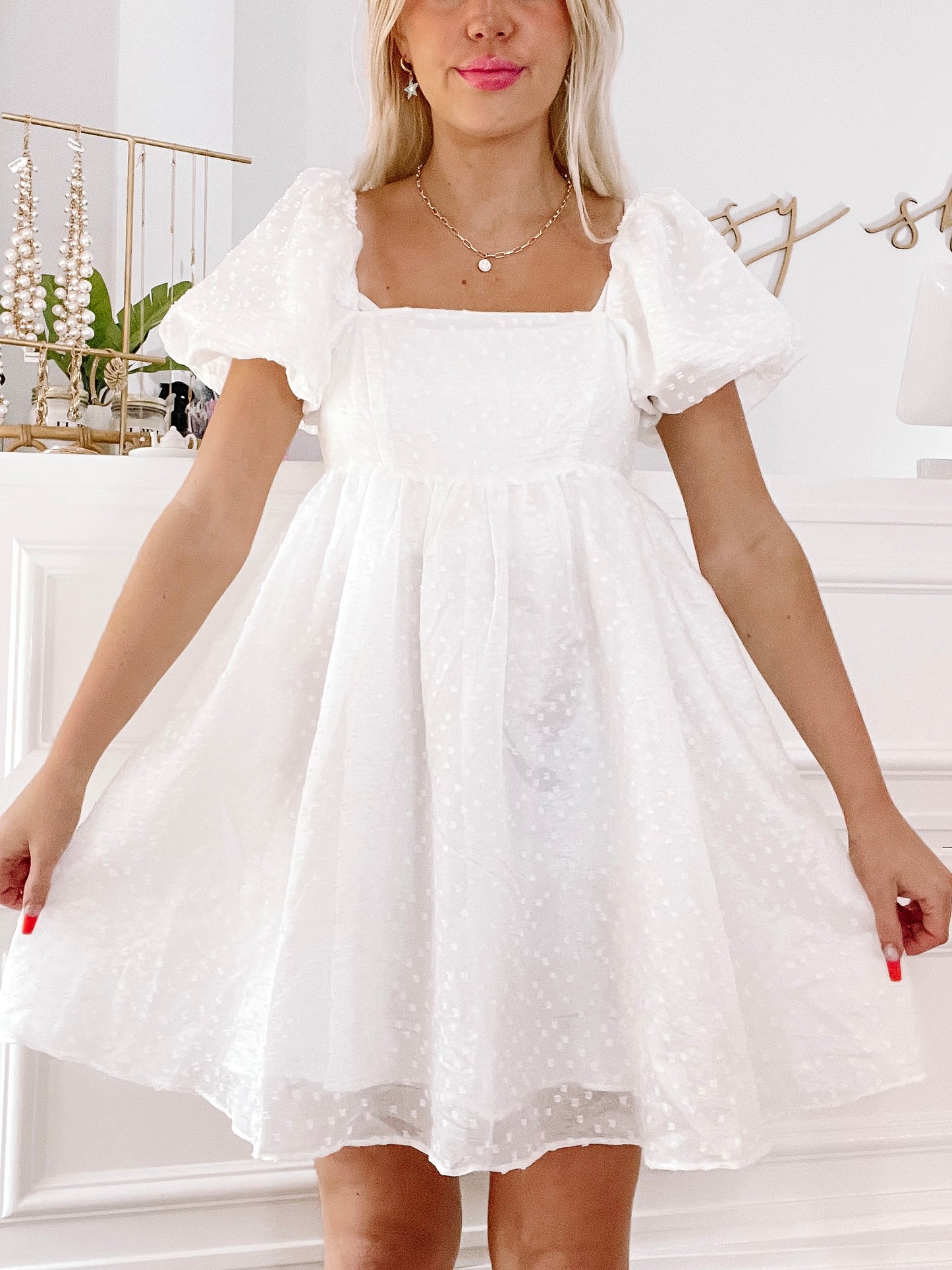 White eyelet Princess Daisy dress with puff sleeves.