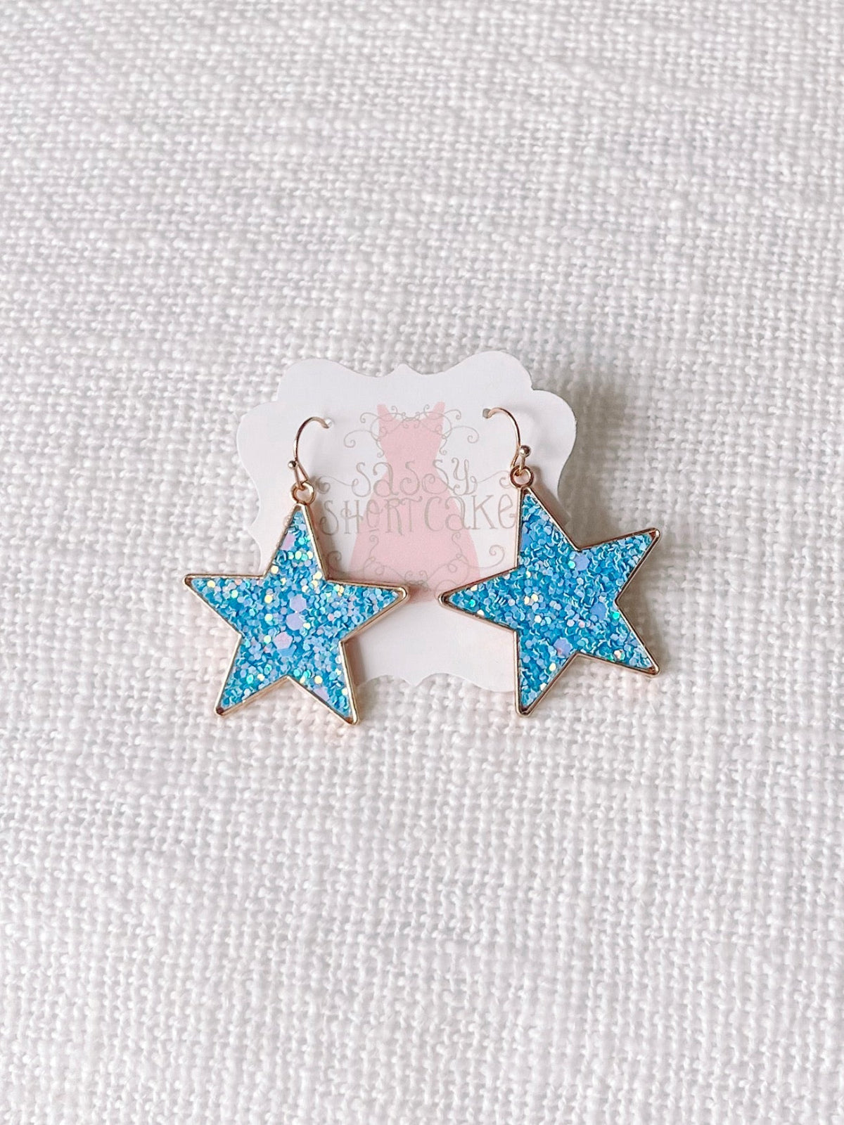 Blue Chasing Stars glitter star earrings with gold hoops from Sassy Shortcake