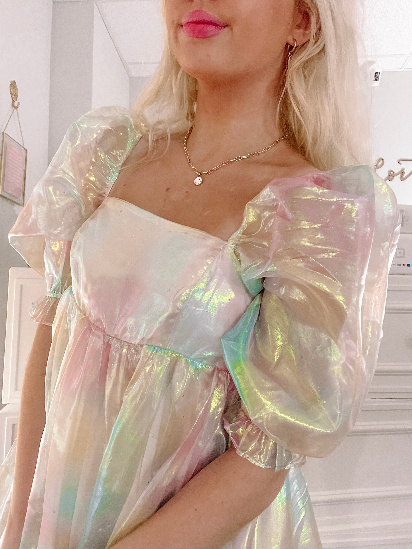 Iridescent pastel mini dress with puff sleeves, shown on a model.