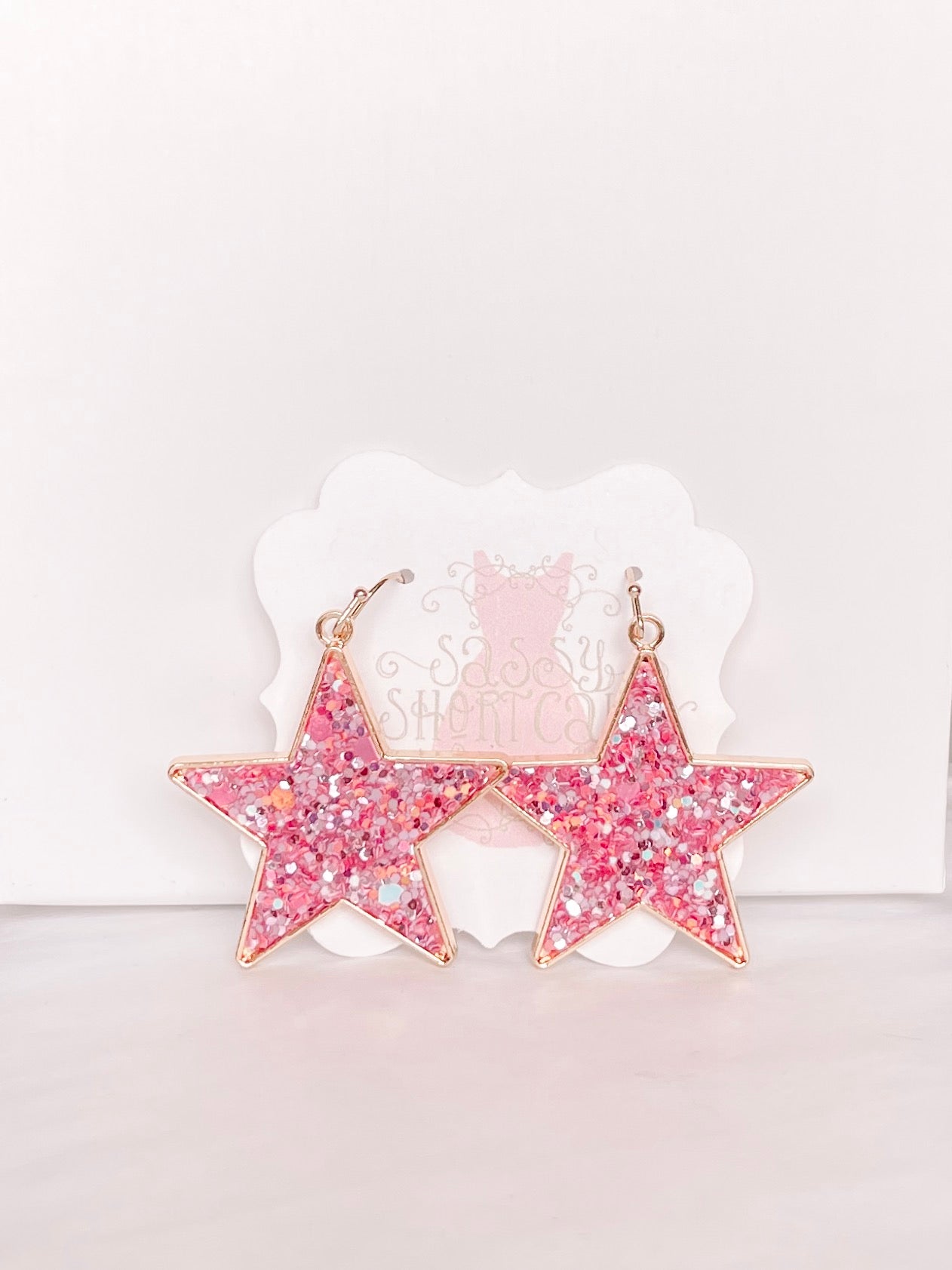 Pink glitter star earrings with gold accents; Chasing Stars design.