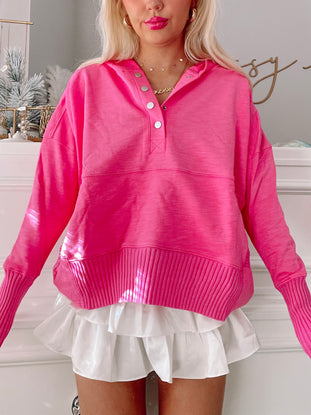 Hot pink Lana pullover sweater with button placket and ribbed cuffs.