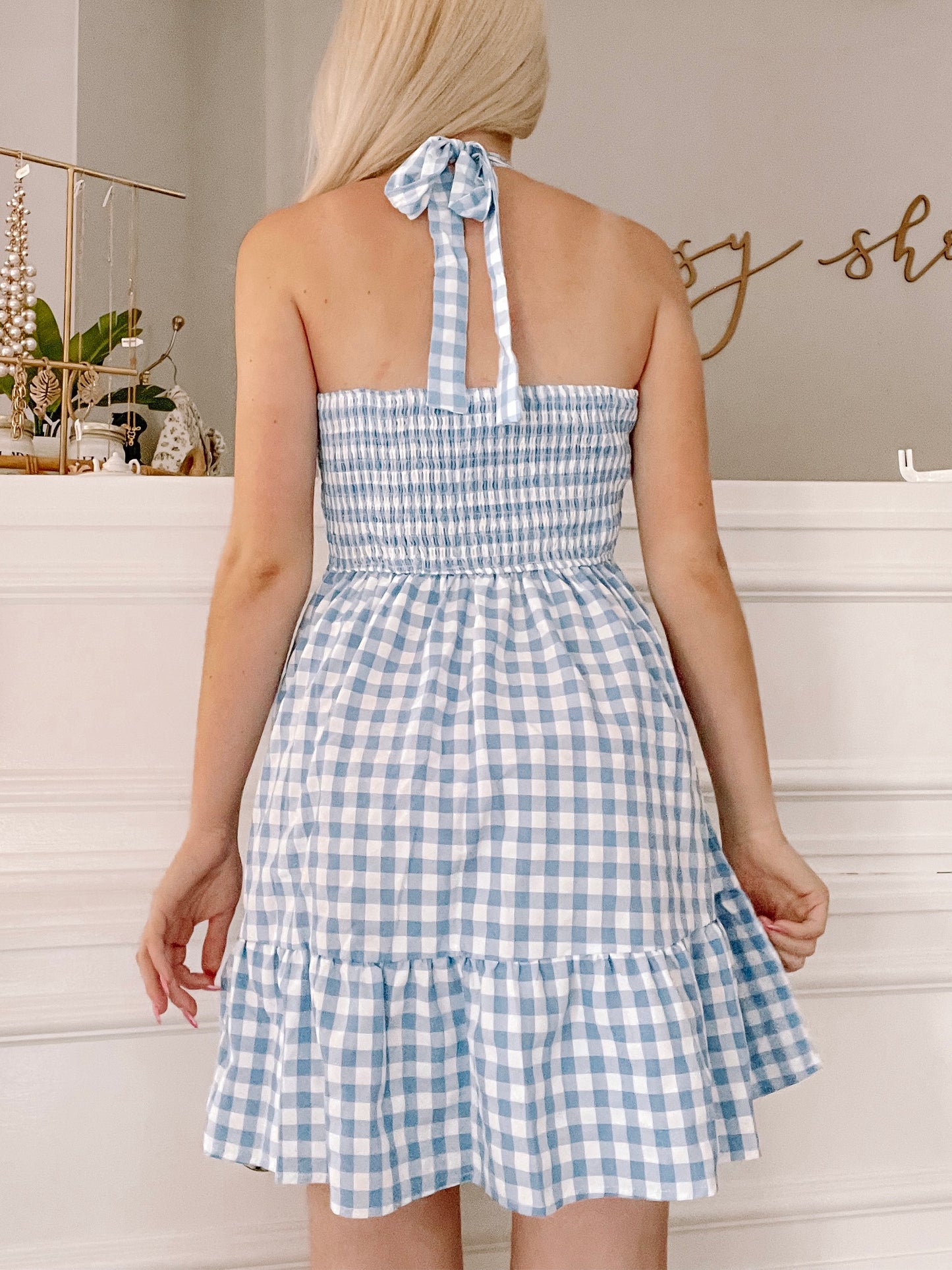 Blue gingham halter dress with smocked bodice and tiered ruffle hem, shown from the back.