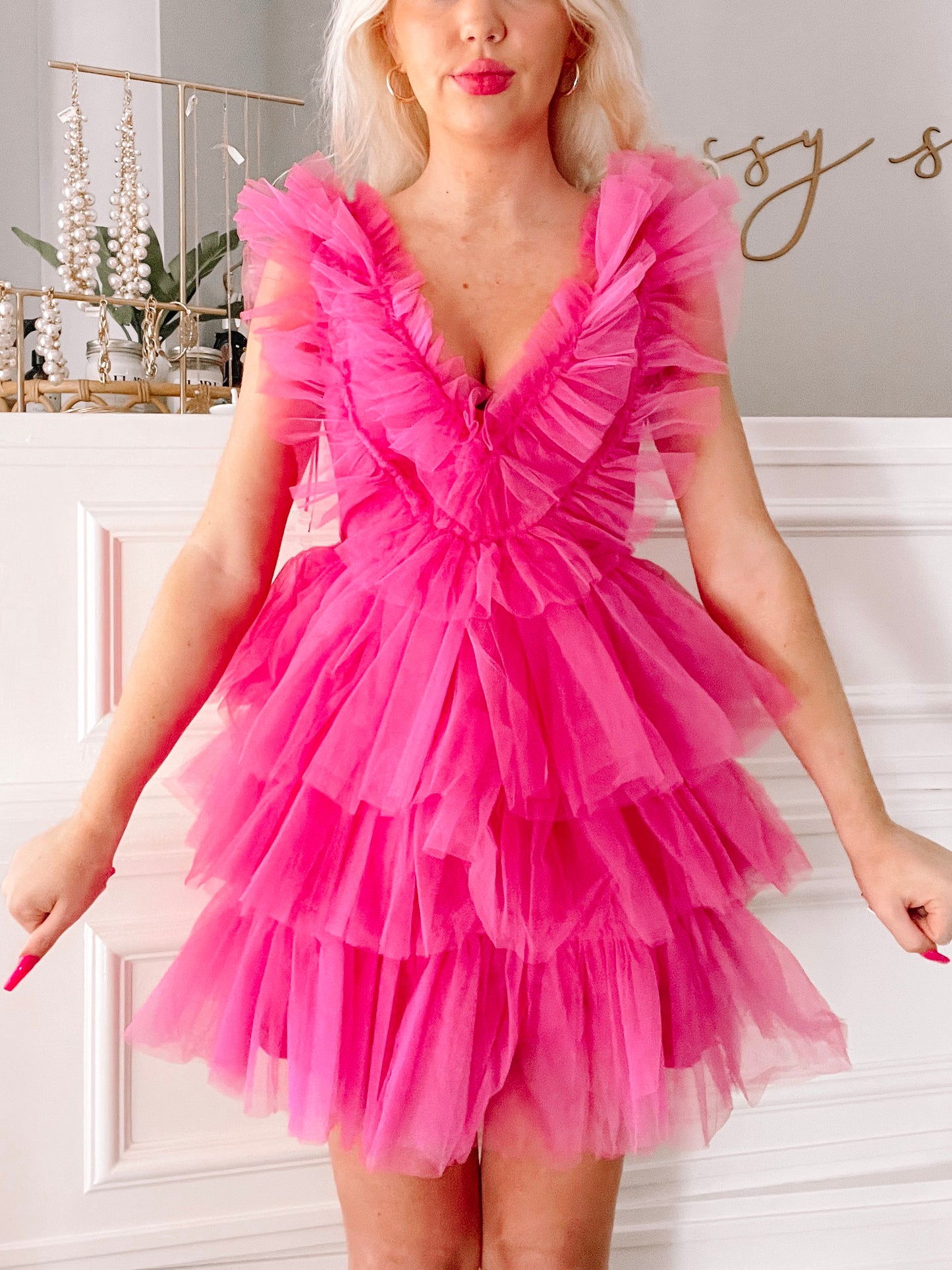 Hot pink tulle mini dress with layered ruffles, shown on a model.