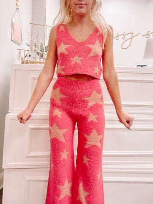 Pink star-patterned pajama set, cozy knit fabric, wide-leg pants.