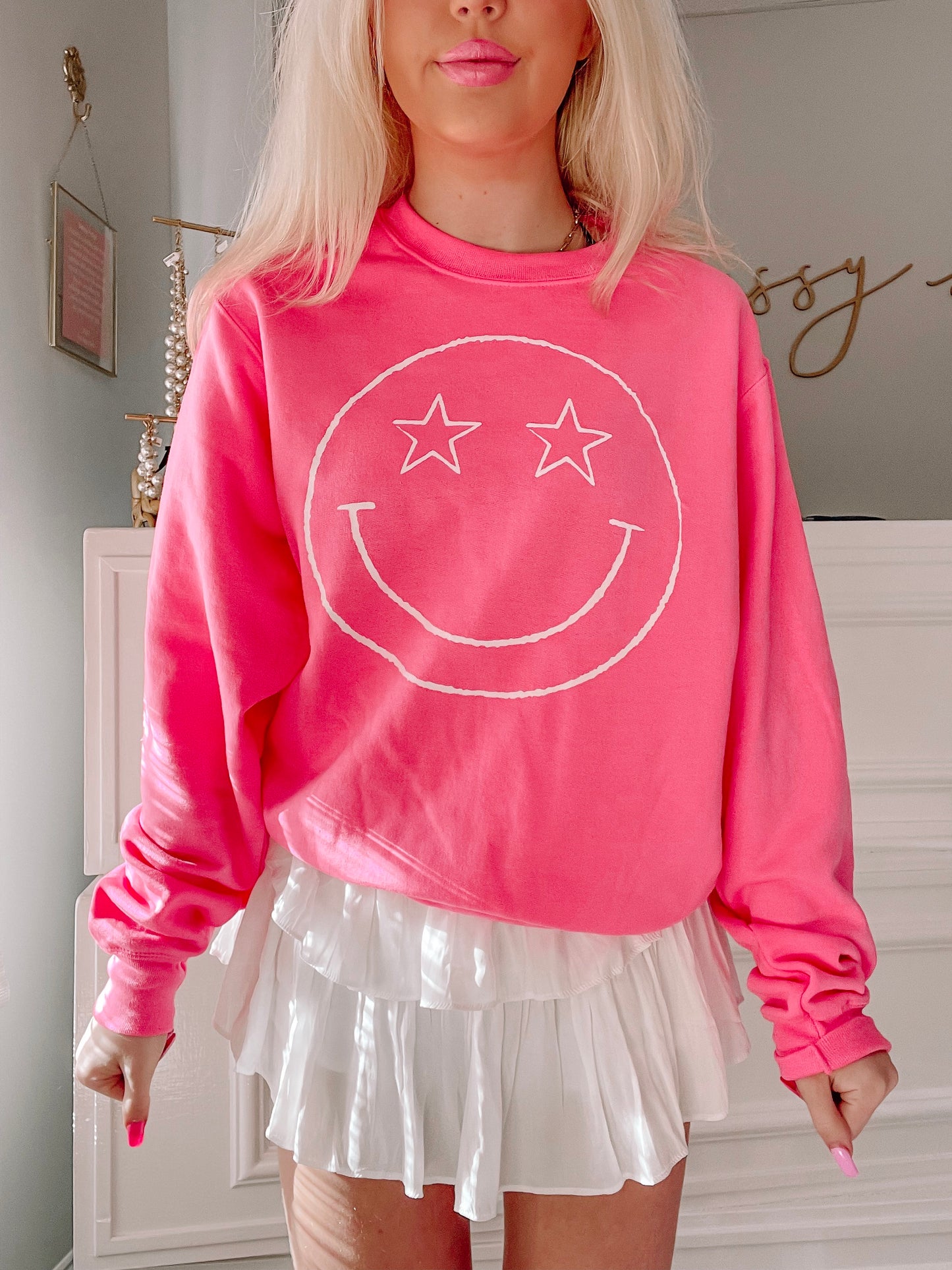 Pink Star Eyed Smiley crewneck sweatshirt with white smiley face graphic