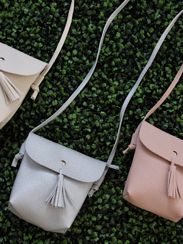 Girl On The Go crossbody purses: Stylish faux leather, tassel detail, perfect for kids.