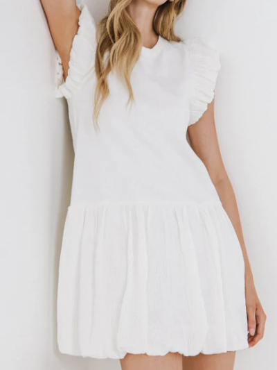 White cotton Counting On You dress with ruffled sleeves and bubble hem.