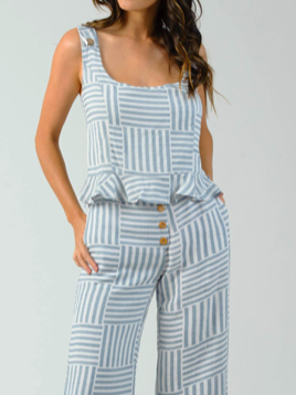 Blue and white striped peplum top with a ruffled hem, shown on a model against a neutral background.