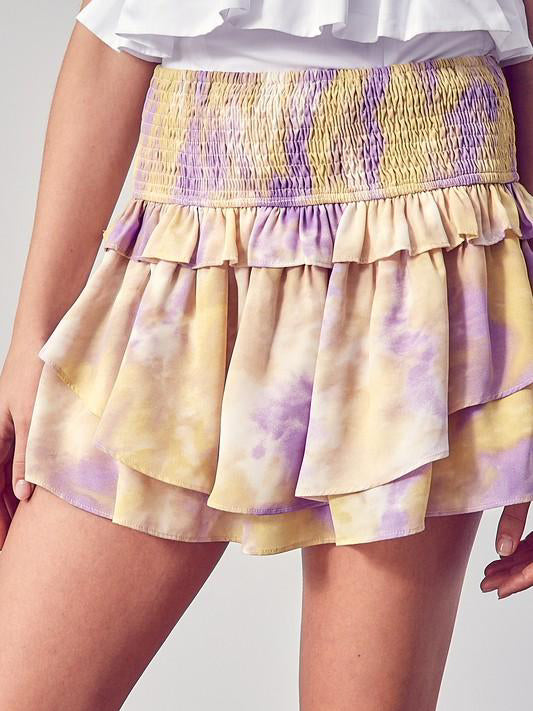 Yellow and purple tie-dye ruffle mini skirt with elastic waistband.