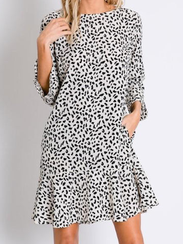 Cream-colored dalmatian print mini dress with 3/4 sleeves and ruffled hem.