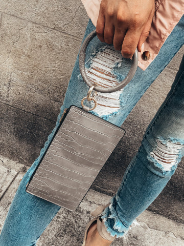 Gray crocodile-embossed Mandy wristlet with a large ring handle.