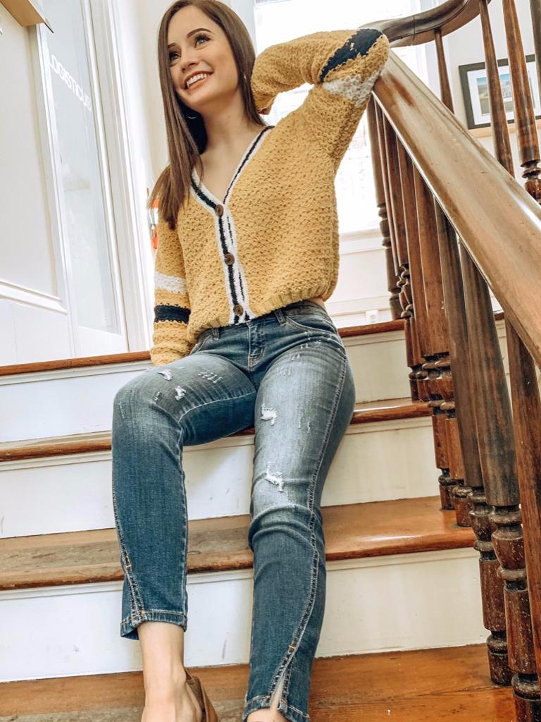 Mustard yellow Cold Hearted cardigan with contrasting sleeve stripes; button front.