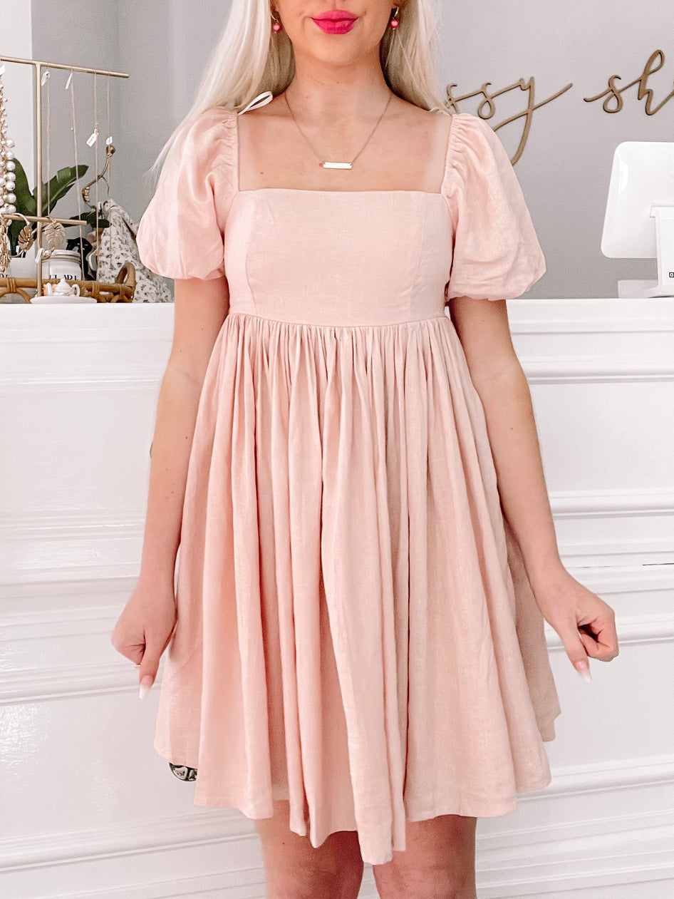 Lush and Lemons pink mini dress with puff sleeves and square neckline.