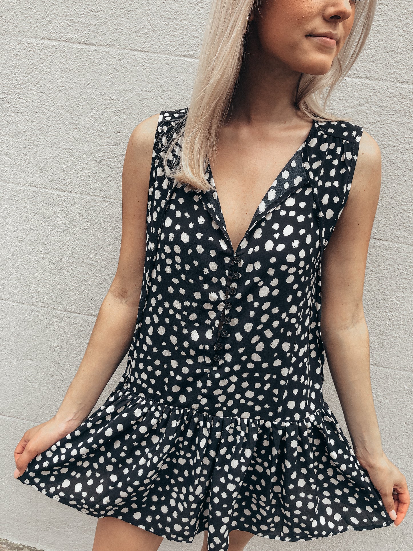 Black and white dalmatian print Give and Take button-front mini dress with ruffle hem.