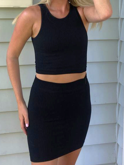 Black ribbed mini skirt, casual summer outfit, close-up.