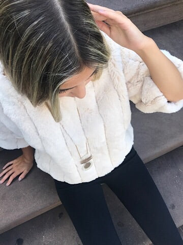 Cream faux fur Sway Away top with 3/4 sleeves, modeled on a woman.