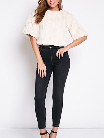 Cream faux fur cropped top with puff sleeves, modeled with dark wash skinny jeans.