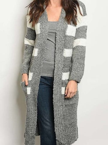 Gray and white striped long cardigan sweater with pockets, shown on a model.