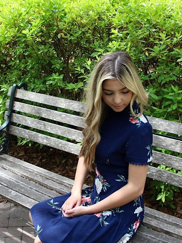 Floral navy dress on a park bench.
