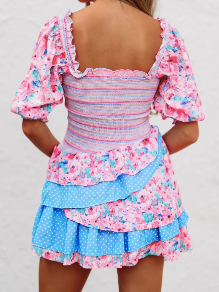 Pink and blue floral mini dress with ruffled tiered skirt, square neckline, and short puff sleeves.