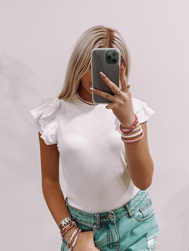 White Londyn Top: Ribbed, ruffle-sleeve top with eyelet detail.