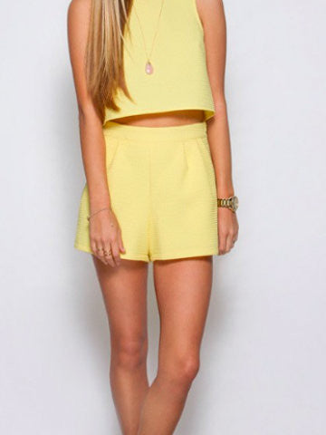 Pale yellow shorts and matching crop top summer outfit.
